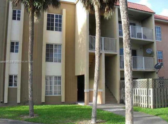 Front view of a multi-story residential building with balconies.