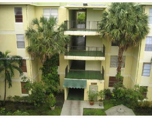 Front view of a multi-story apartment building with balconies.