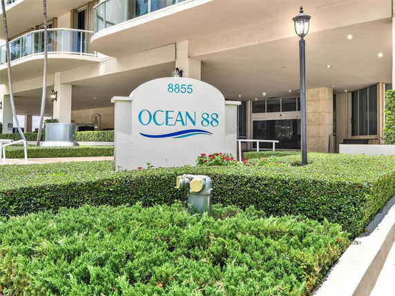 Front view of a modern multi-story building with balconies and a sign reading 'Ocean 88'.