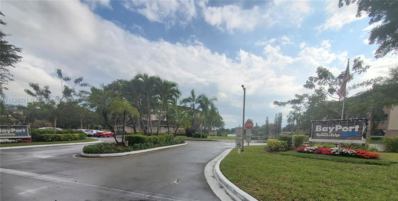 Entrance view of BayPort township with road and landscaping