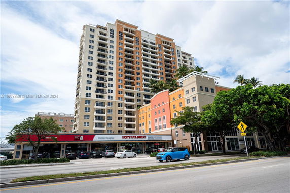 Front view of a multi-story residential and commercial building.