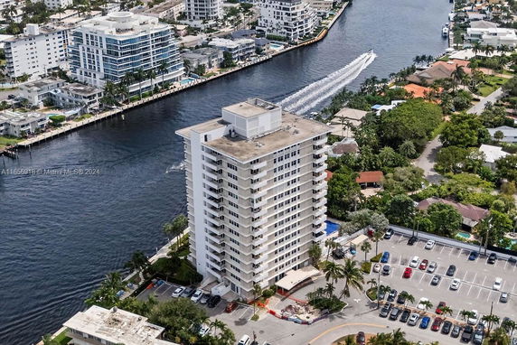 High-rise building near a waterway with surrounding urban area.