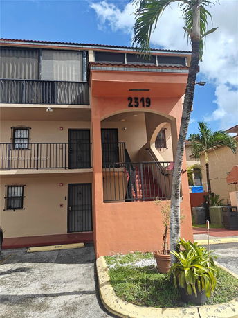Front view of a multi-story building with stair access and balconies.