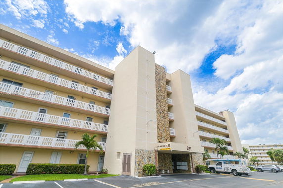 Front view of a multi-story residential building with balconies.