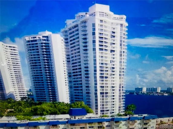 View of multiple high-rise residential buildings near a body of water.