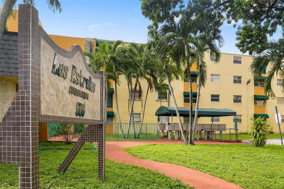 Front view of a multi-story condominium building with a sign reading 'Las Estrellas Condominium'.