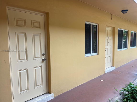 Exterior view of a building with beige doors and windows.