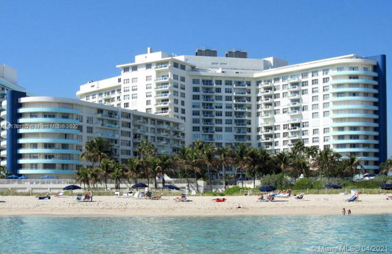 Front view of a large beachfront apartment complex with multiple balconies.