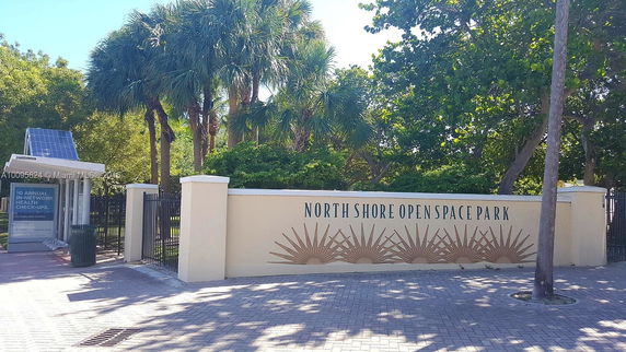 Entrance to North Shore Open Space Park with a sign and trees in the background.