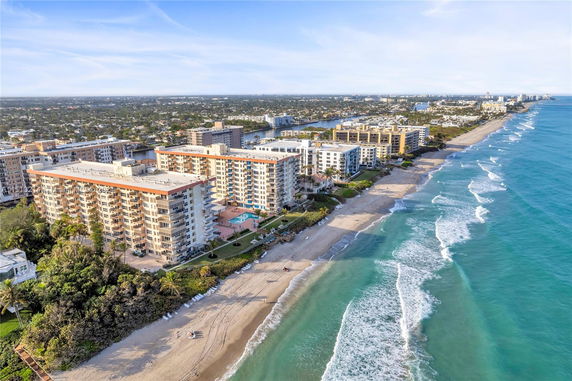 Aerial view of beachfront buildings overlooking the ocean.
