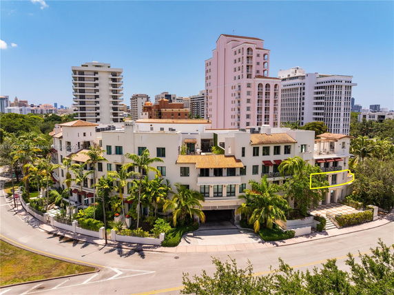 Front view of a multi-story residential building with a Mediterranean architectural style.