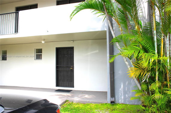 Front view of a building entrance with a single door and small windows.