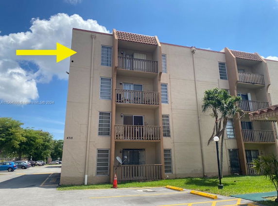 Front view of a multi-story residential building with balconies.