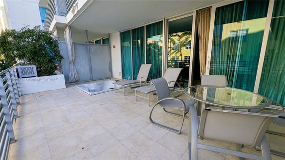 Rooftop area with outdoor seating and hot tub.