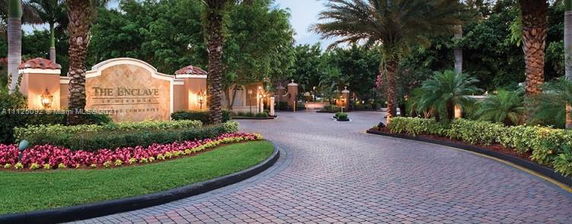 Entrance to a residential community with landscaped gardens and pathway.