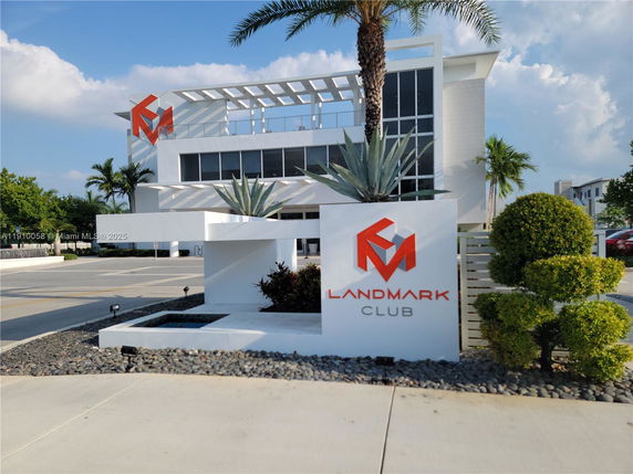 Front view of a modern building labeled 'Landmark Club' with a sleek exterior design.