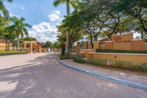 Front view of a gated entrance to a residential community named Villa Vizcaya.