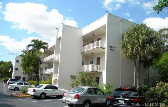 Front view of a multi-story residential building with balconies.