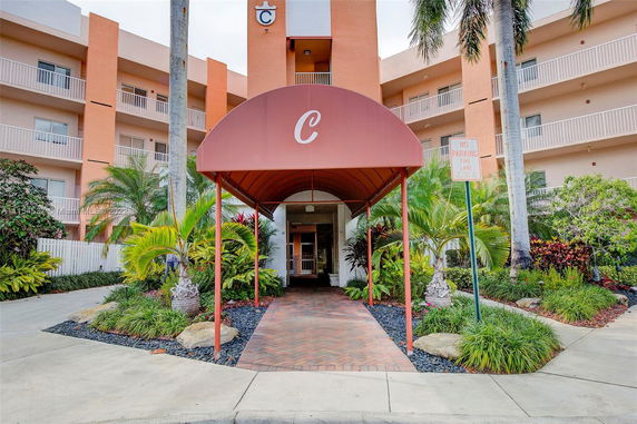 Front view of a multi-story building with a covered entrance.