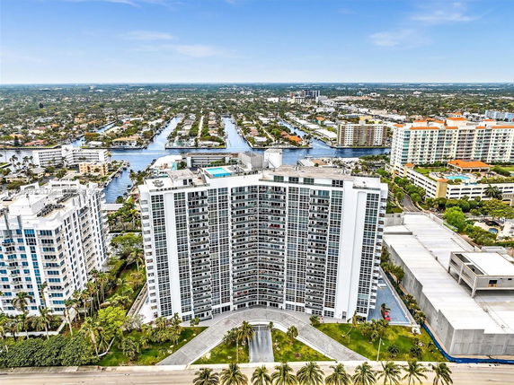 Front view of a high-rise residential building with multiple balconies.