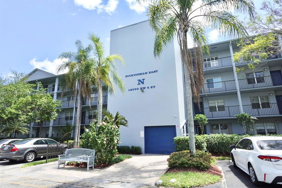 Front view of a multi-story residential building with balconies.