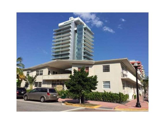 Front view of a modern multi-story building with balconies.