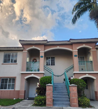 Front view of a two-story building with stair access.