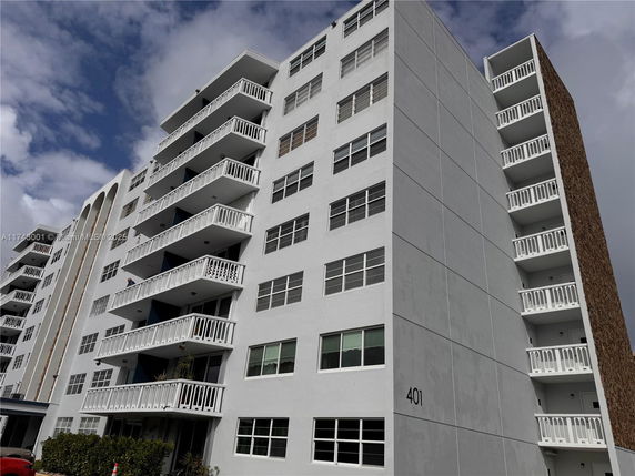 Front view of a multi-story residential building with balconies.