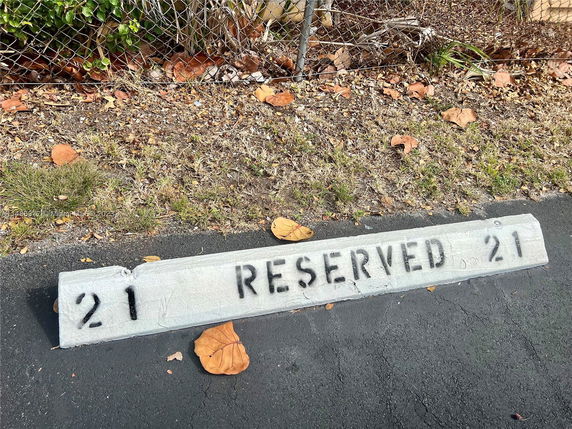 Reserved parking spot number 21 marked on pavement.