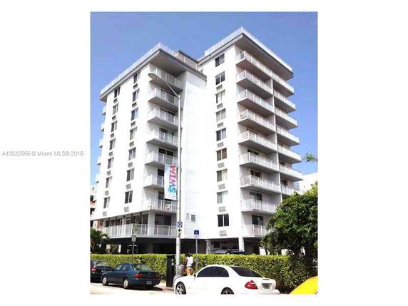 Front view of a multi-story apartment building with balconies.