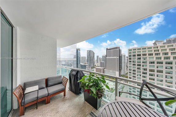 Balcony view overlooking a cityscape with high-rise buildings.