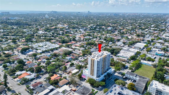 Aerial view of a high-rise building surrounded by a sprawling urban landscape.
