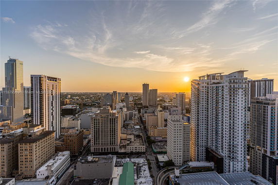 Panoramic view of city skyscrapers during sunset.