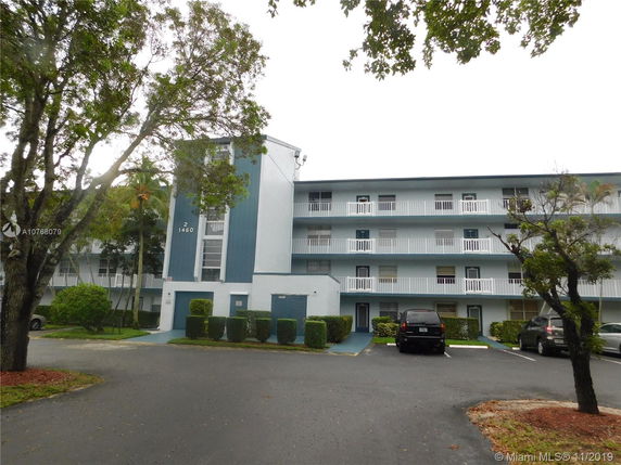 Front view of a multi-story residential building with balconies.