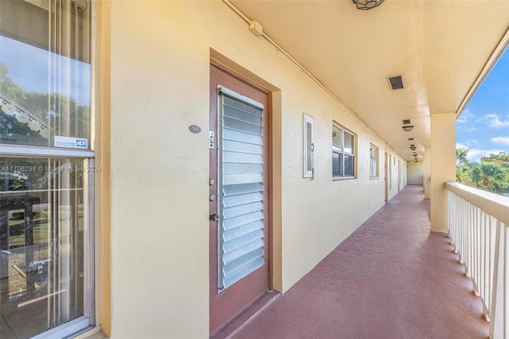 Exterior hallway with doors and windows of a building.