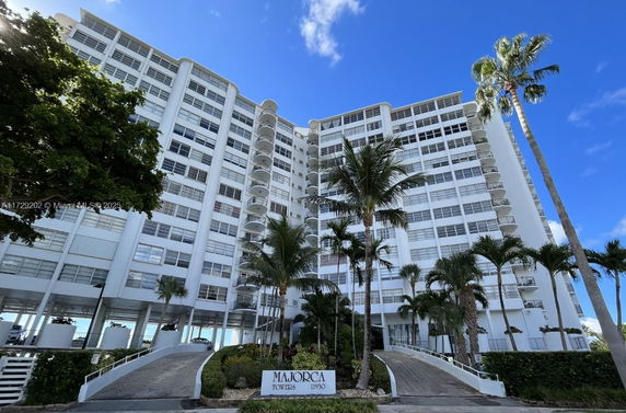 Front view of a multi-story residential building with balconies.