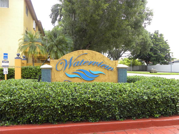View of a multi-story building with yellow exterior and a sign reading 'Waterview.'