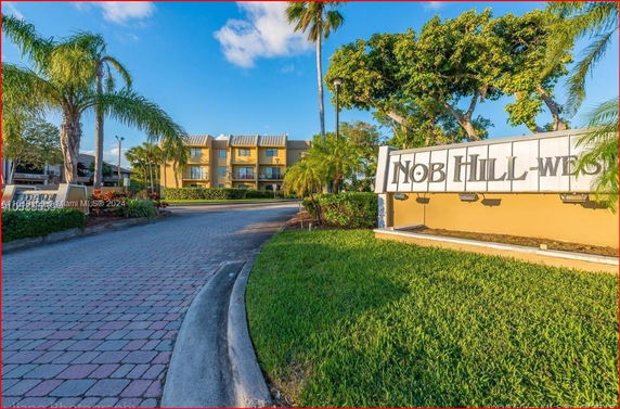 Front view of a multi-story residential building with a sign reading 'Nob Hill West'.