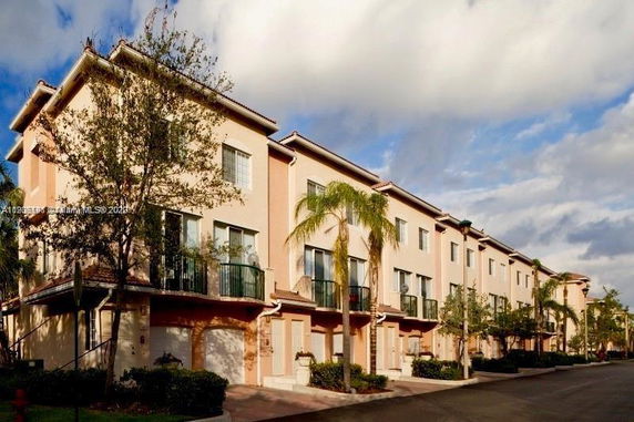 Front view of a row of multi-story townhouse buildings.