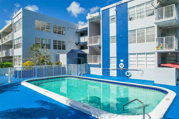 Outdoor view of a multi-story building with a swimming pool.