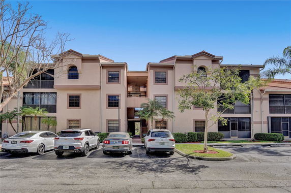 Front view of a multi-story residential building with multiple entrances and balconies.