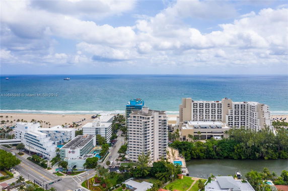 Panoramic view of beachfront buildings with ocean in the background.