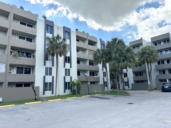 Front view of a multi-story residential building with balconies.