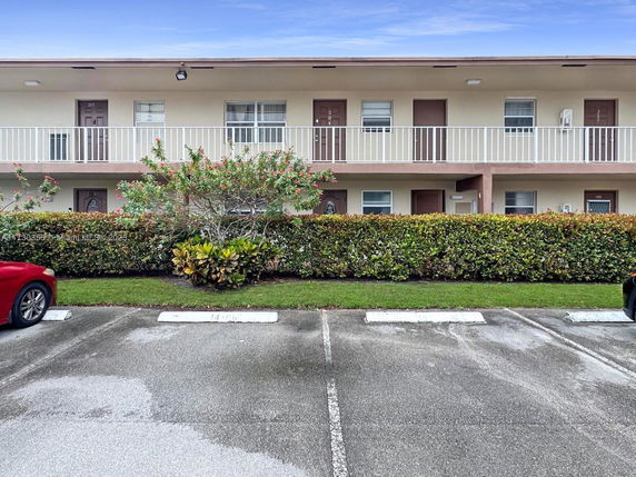 Front view of a two-story apartment building with balconies.