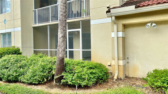 Front view of a building with a screened area and trim details.