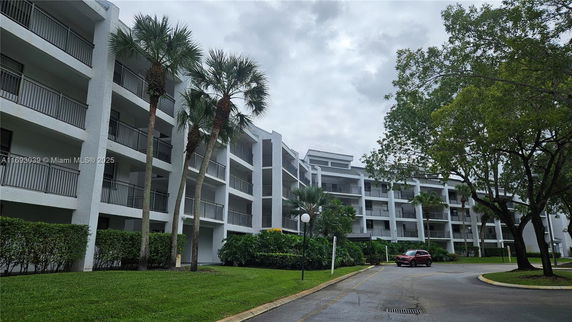 Front view of a mid-rise apartment building with multiple balconies.