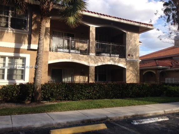 Front view of a two-story residential building with balconies.