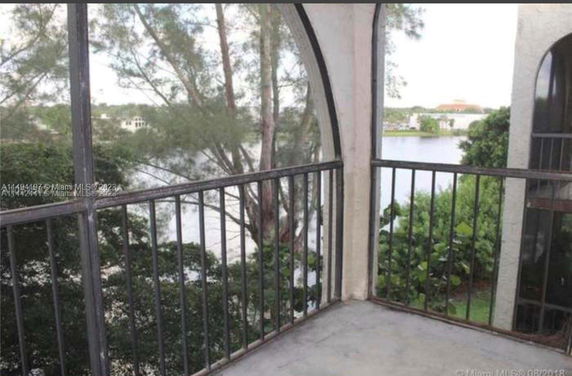 Balcony view overlooking a lake and trees