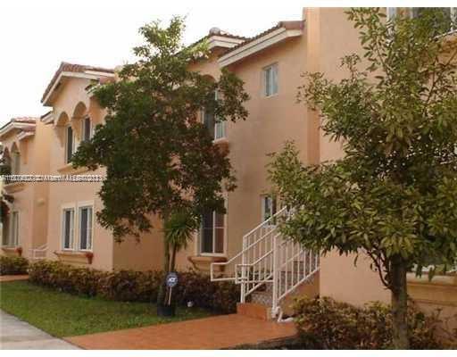 Front view of a multi-story house with exterior steps.