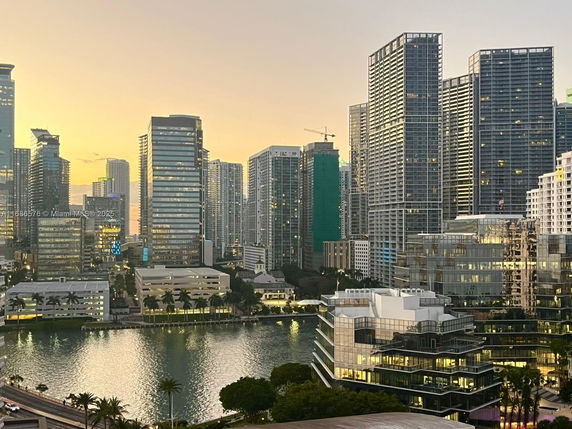 View of cityscape with multiple high-rise buildings and water body.